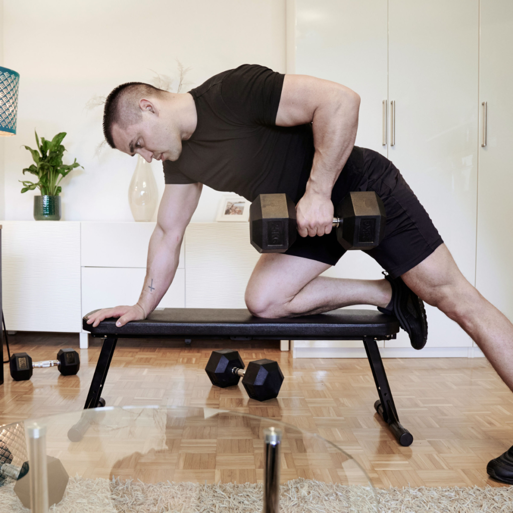 a man lifting weights on a bench