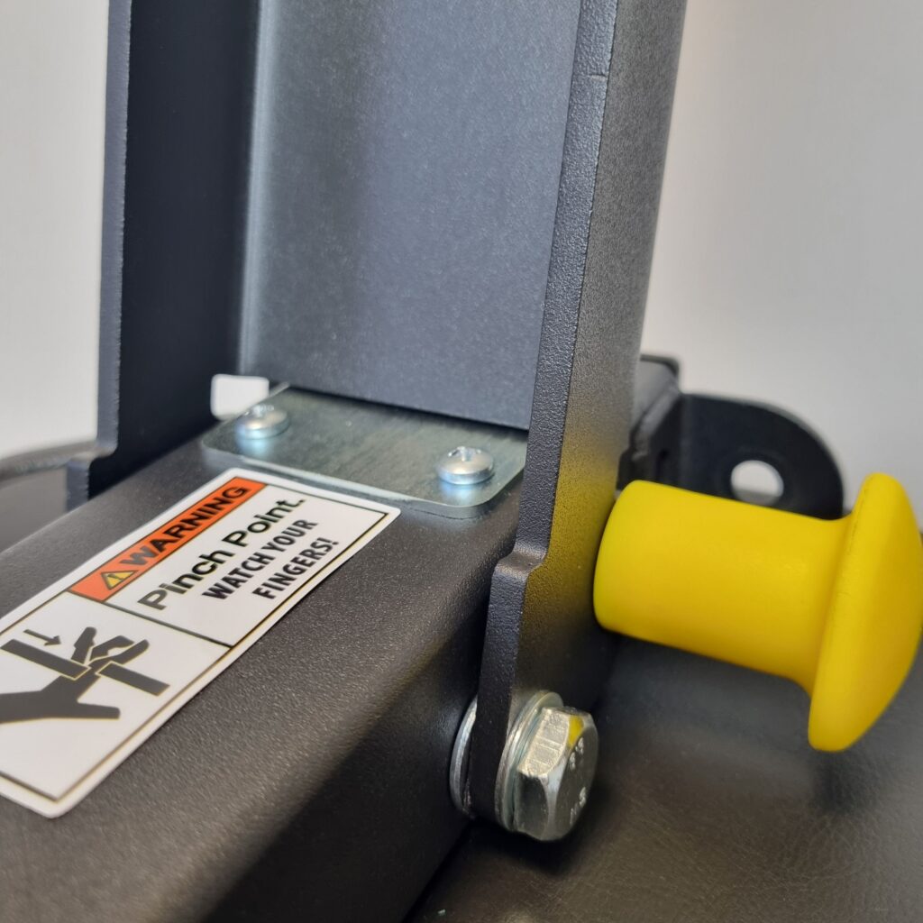 Yellow safety pin inserted in foldable weight bench