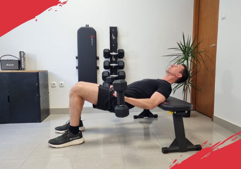Glute bridge exercise being performed with an dumbbell to barbell converter and weight bench