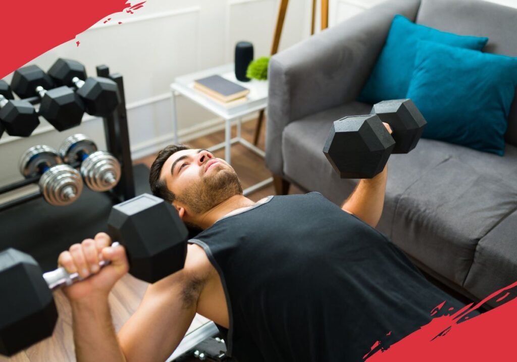 man doing dumbbell press on weight bench at home