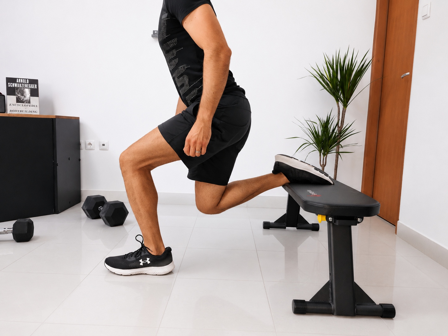 MightyRock bench in studio bulgarian split Fitness model doing bulgarian split squat on the MightyRock bench in home gym