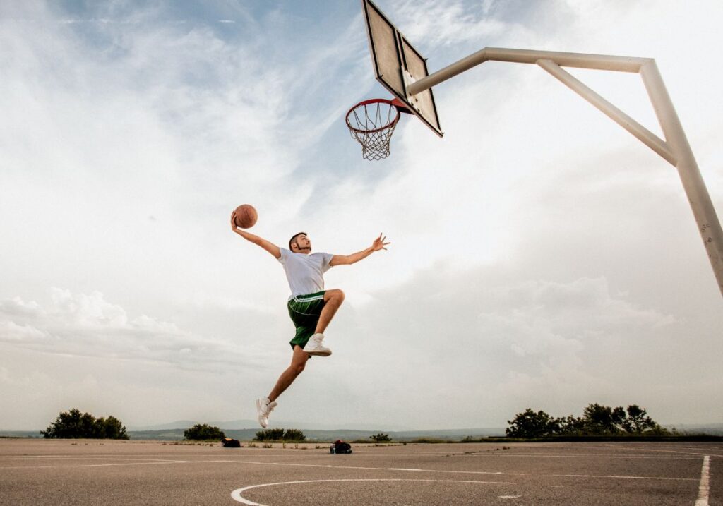 Improve vertical jump at home: basketball player jumping for a dunk